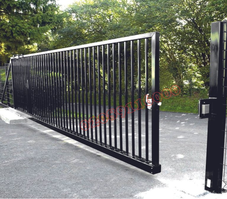 Black metal sliding driveway gate with vertical bars on cantilever track system