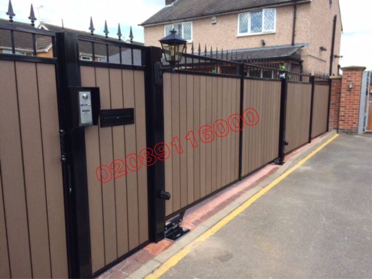Composite driveway gate with tan slats, black railings and video intercom on UK driveway