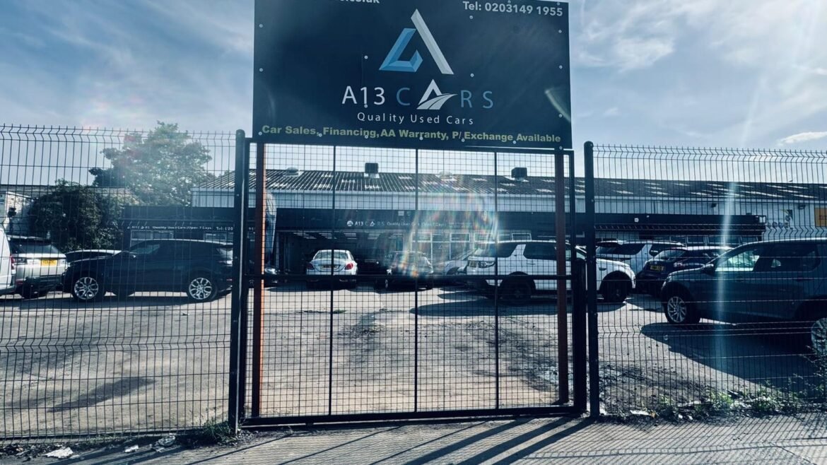 Commercial security gate with branded business sign fitted at car dealership entrance