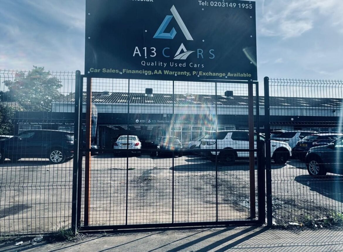 Commercial security gate with branded business sign fitted at car dealership entrance